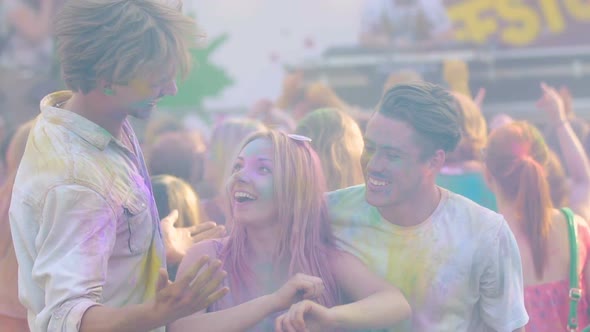 Three Happy Friends Dancing at Open Air Color Festival , Enjoying Life, Slow-Mo