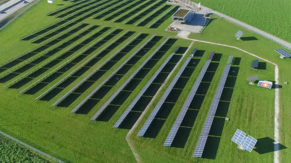 Aerial multishot of solarfarm with highway traffic