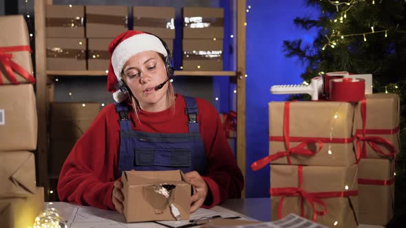 Small Business Owner Caucasian Female Freelancer Santa Works at Home Office Using Computer Holding