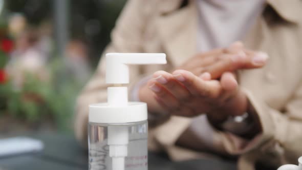 Close Up of Black Woman Hands Using a Hand Alcohol Gel Sanitizer Cleaning To Prevent Spread of Covid