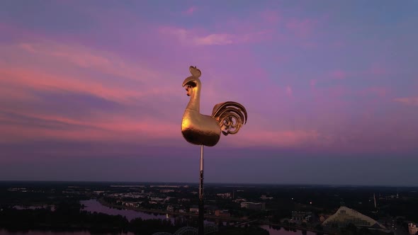 Traditional Golden Weather Cock or Rooster in Riga Old Town During Amazing Scenic Sunrise Aerial