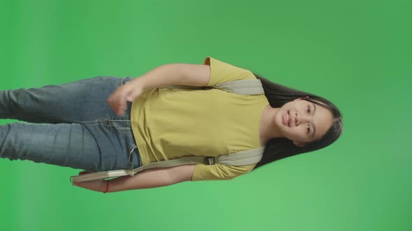 Asian Girl Student Holding Book While Walking To School On Green Screen Chroma Key