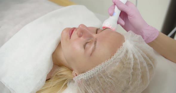 Doctor Performs Cosmetic Procedures In A Beauty Salon On The Face Of A Young Woman