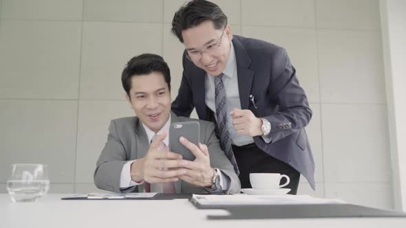 Smart handsome businessmen using smartphone to check stock market data