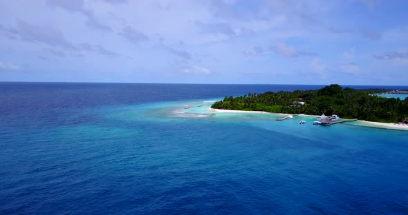 Daytime overhead tourism shot of a white paradise beach and aqua turquoise water background in best 
