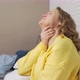 Woman in Sweater Sits on Bed and Coughs and Sneezes - VideoHive Item for Sale