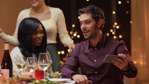 Friends Having Christmas Dinner and Taking Selfie