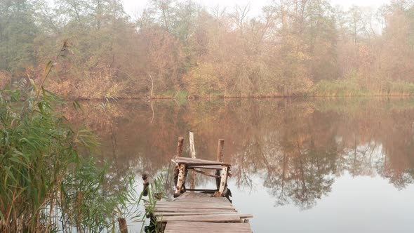 A Small Fishing Jetty on the Bank of a Misty River in Autumn - Dolly in Shooting