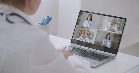 Close Up of Young Female Talk on Video Call Consult with Diverse Doctors Colleagues, Woman Patient