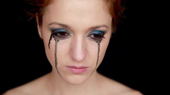 Young Woman Crying on Black Background