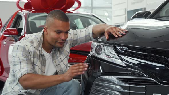 Handsome African Man Showing Thumbs Up While Examining New Car