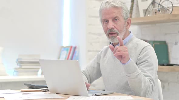 Old Man Pointing With Finger Toward Camera