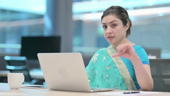 Indian Woman with Laptop showing Thumbs Down Sign