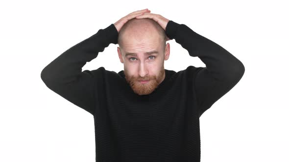 Portrait of Nervous Man with Red Beard and Mustaches Touching His Face Expressing Problem or Stress