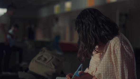 Talented Schoolgirl Drawing Sketches on Lively School Break Sitting Corridor