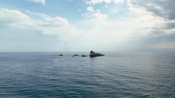 Tugs help the gas tanker to go to sea aerial view 4 K Turkey Alanya