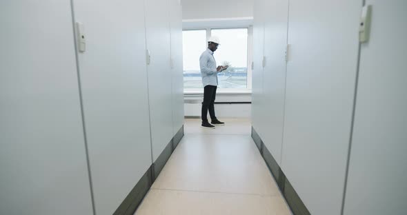 Portrait of an Engineer in a Hard Hat Holding a Tablet