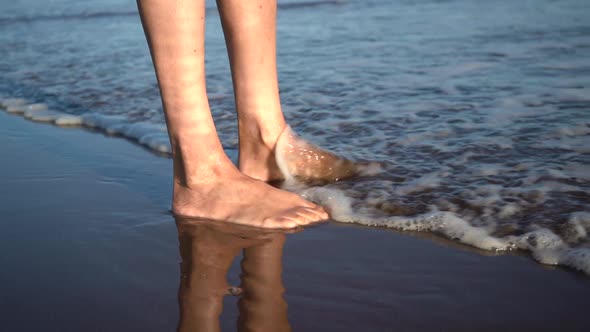 Waves Splashing Over Feet On The Beach - slow motion