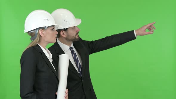 Engineers Looking at Construction Work Against Chroma Key