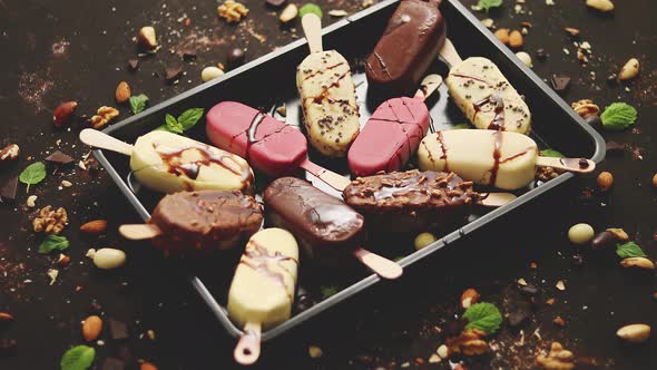 Assortment of Various Popsicle Ice Cream, White and Dark Chocolate, with Almonds, Rusty Background