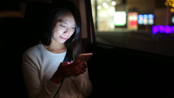 Young woman looking looking at smart phone