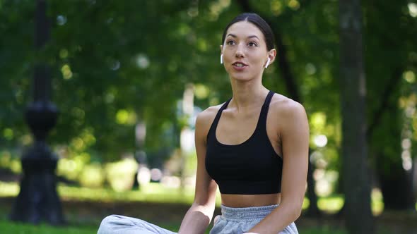 Girl Listening To Music in Lotus Position