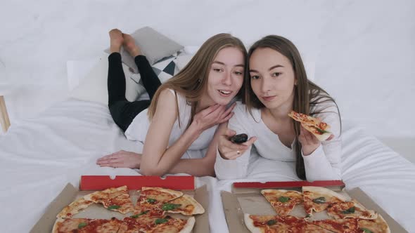 Girls Friends Eats Pizza and Watching TV at Home