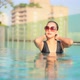 Young asian woman enjoy around outdoor swimming pool for leisure - VideoHive Item for Sale