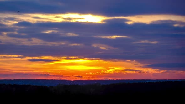 Dramatic Sunset in the Sky Through Orange Layered Cumulus Clouds Timelapse