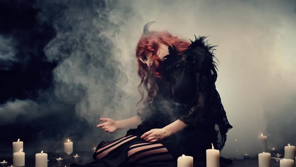 Candles Placing Around Female Demon, Smoke Rising. Woman Dressing in Dark Casts, Spelling