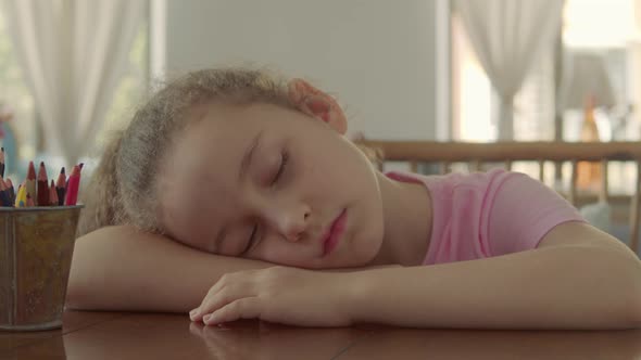 Closeup Face of a Little Girl a Child Tired on a Hot Day Tries to Fall Asleep on His Side in His