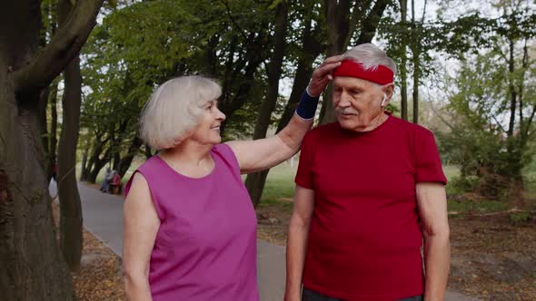 Mature Family Couple Together After Running Using Smart Watch, Tracking Result of Fitness Workout