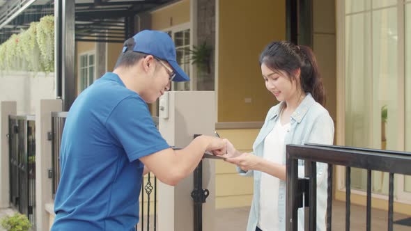 Young postal delivery courier man holding parcel boxes for sending to customer.