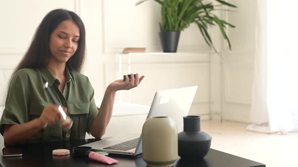 Female Make Up Artist Holding Brush and Powder and Holding Webinar