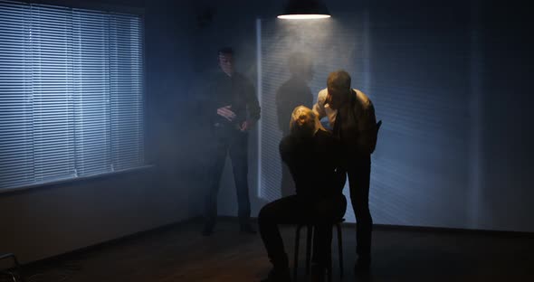 Criminals Torturing Caught Men in Dark Room