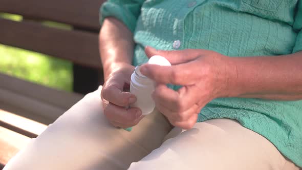 Woman's Hands Opening Pill Bottle.