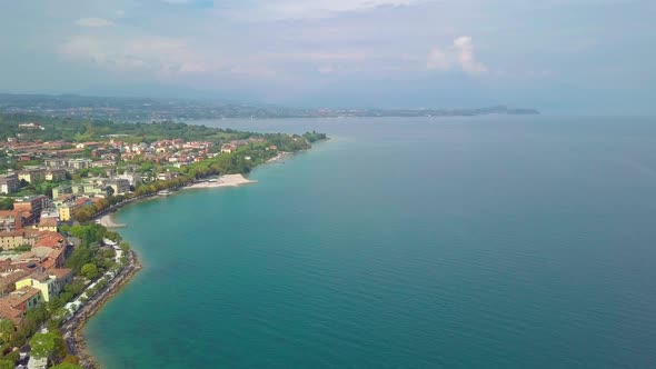 Aerial View of Boats and Coast of Lake Garda, Italy. Flying Over Boats and Shoreline of Lago Di