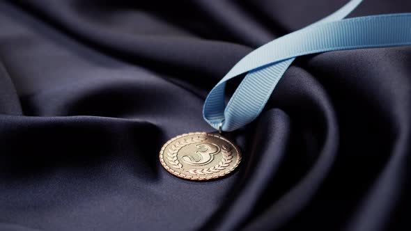 Bronze Medal with Ribbon on Black Background Closeup