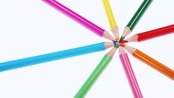 Multicolored Children's Pencils Rotate on a White Background.