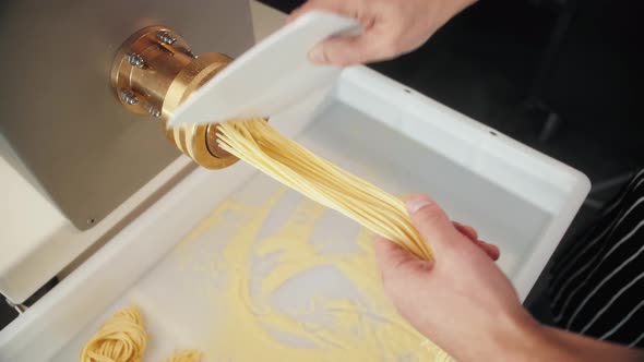 Man Making Fresh Pasta on Traditional Italian Kitchen Machine for Spaghetti Chef Preparing Fresca