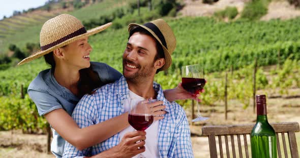 Couple having wine in the farm