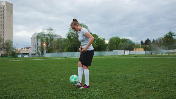Portrait of Woman Football Player in Full Growth in the Evening Park