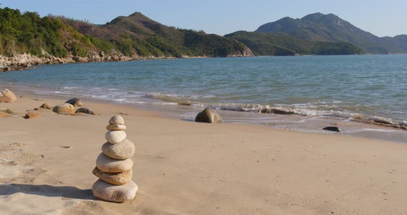 Zen balance stone on the sand