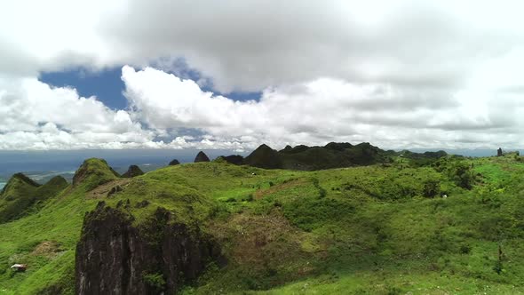 Aerial view of Chocolate hills and cloudy sky in Badian, Philippines.