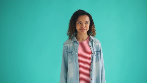 Portrait of Beautiful African American Student Looking Around Winking at Camera