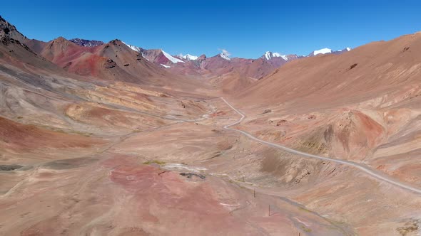 Drone View of Curved Road Crossing Hot Desert