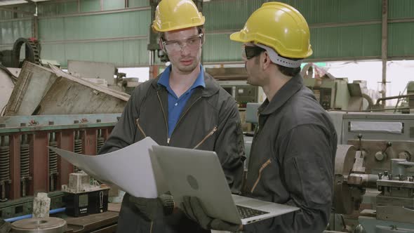 Two engineer man and partner work with laptop computer and having agreement for success.