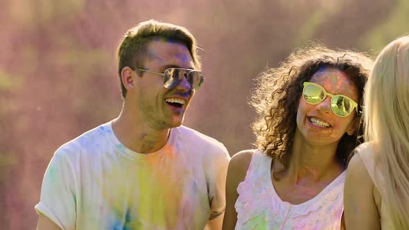 Two Dancing Couples Covered in Colored Powder, Happy Friends Enjoying Party