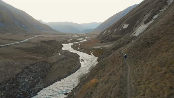 Static View Of Hiker Solo Exploring Beautiful Valley(Log)