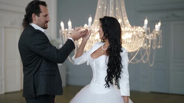 Happy Young Bride is Dancing with Her Beloved Groom in Wedding Day